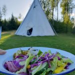 A healthy salad with a Tipi in the background at the Women's Retreat
